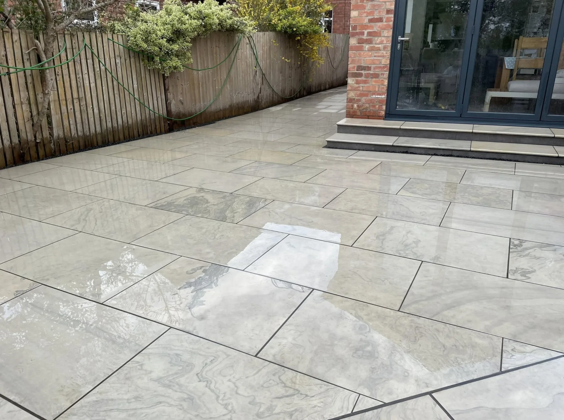 Finished porcelain patio beside a home