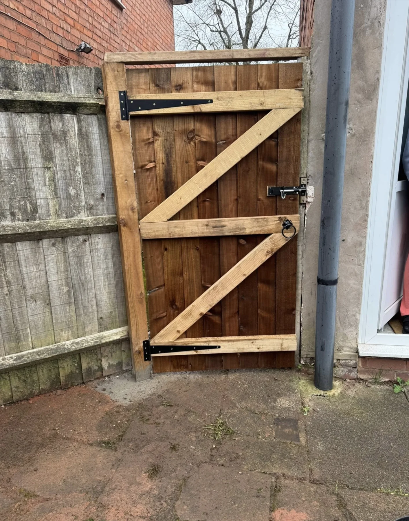 Hand-built timber side gate with black ironwork