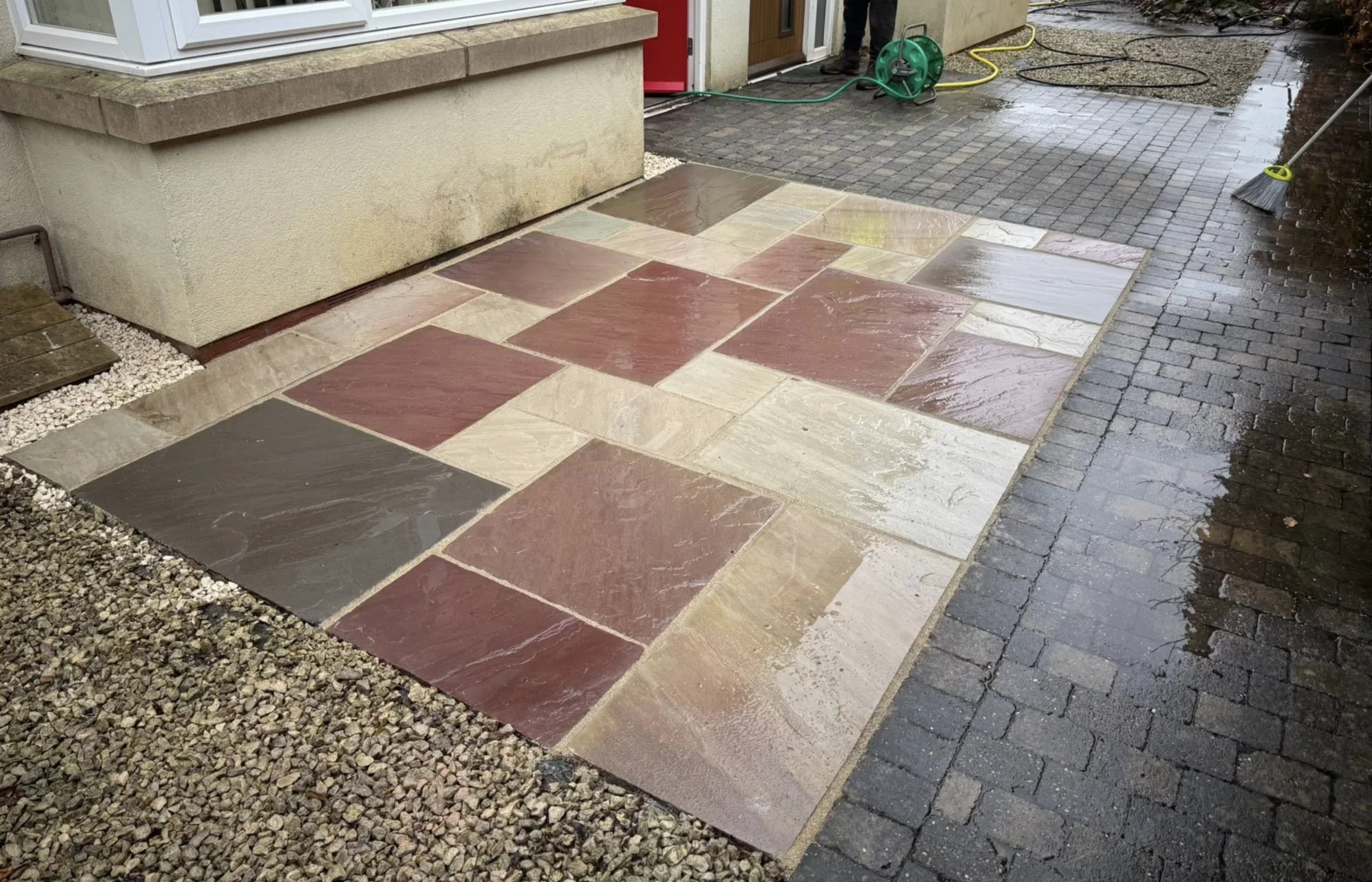 Mixed paving path finished beside a home