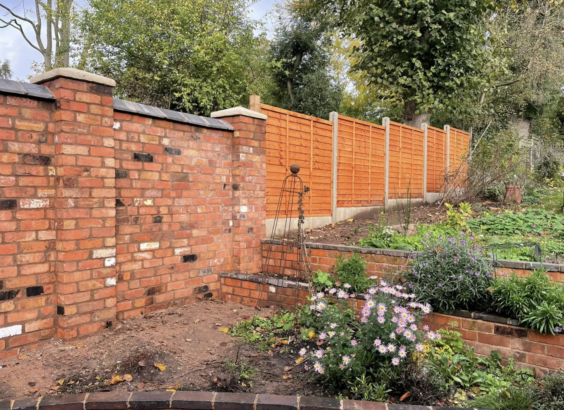 Finished brickwork, fencing and planted garden borders