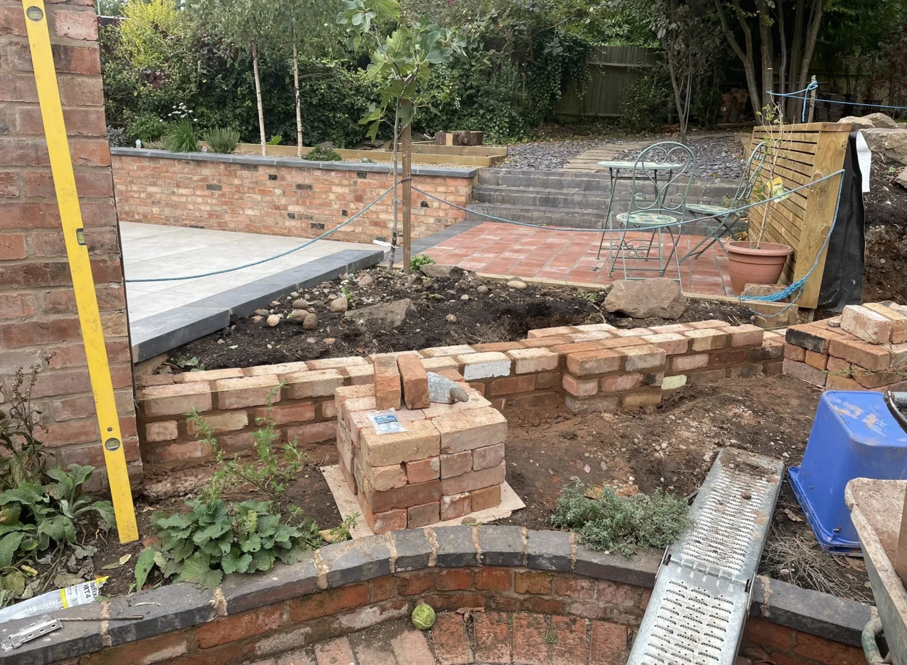 Brick raised beds and steps being built in a garden