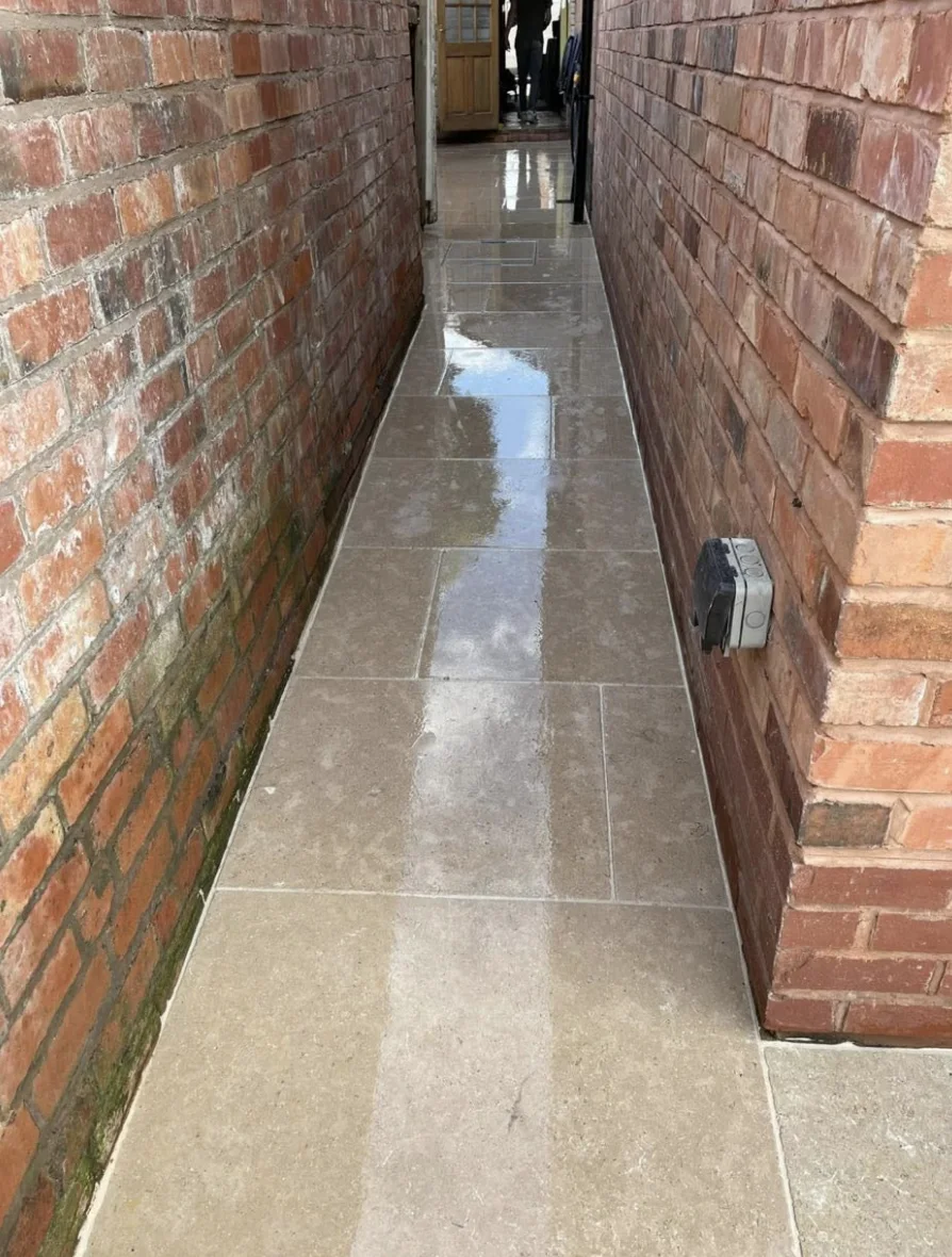 Newly laid paving in a narrow brick passageway
