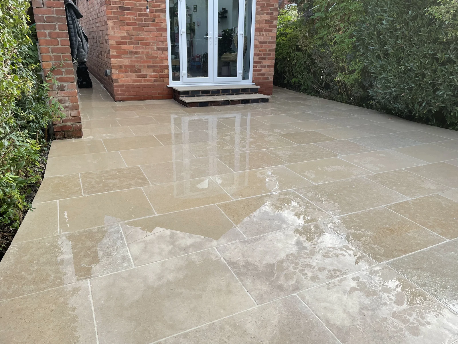 Finished porcelain patio beside a home